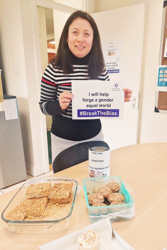 Carbon Group employees hold banners supporting International Women's Day 2022