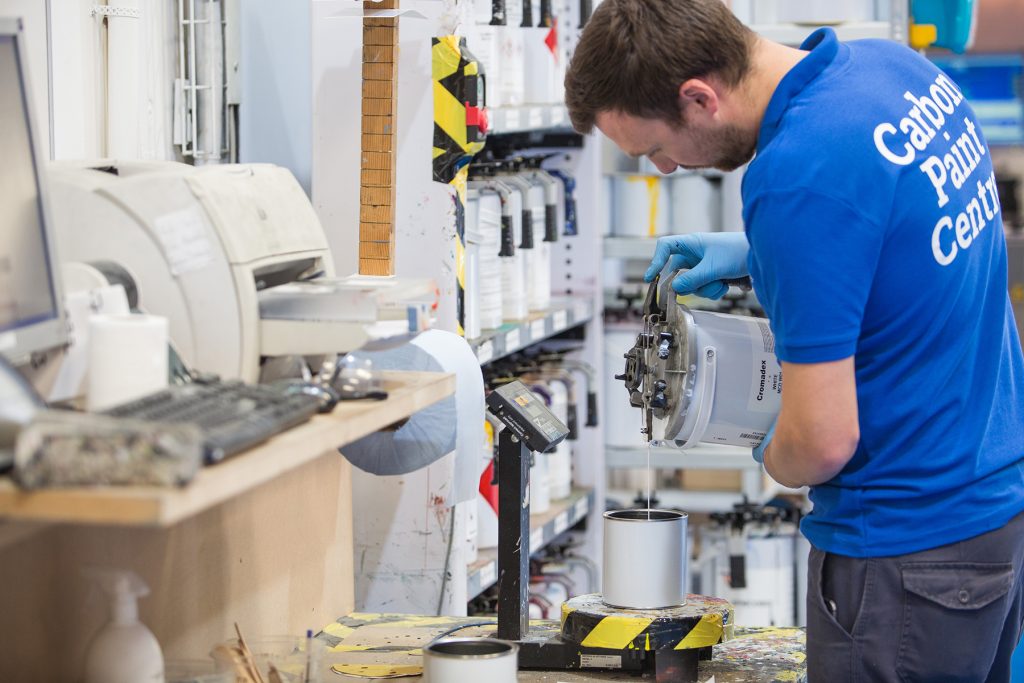 Carbon Paint Centre employee mixing paint