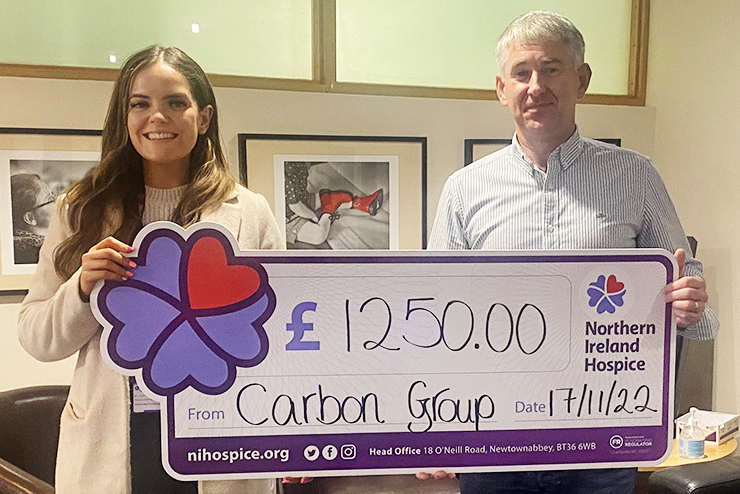 Carbon Paint Centre's Fintan presents a donation cheque to Northern Ireland Hospice
