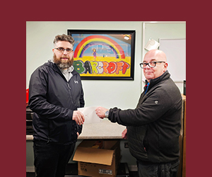 Carbon Paint Centre's Paul McGuinness makes a donation presentation.